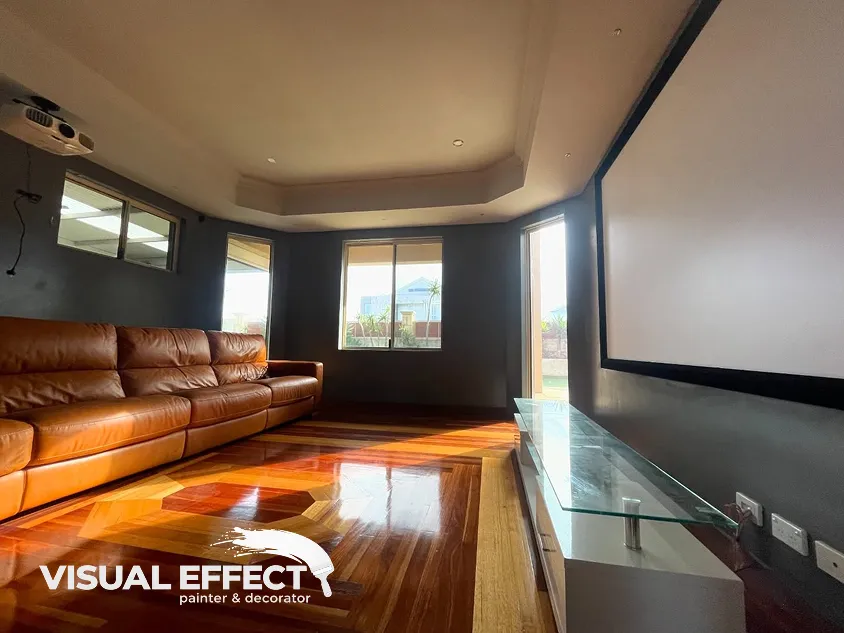 Home theatre with a recessed ceiling and dark walls painted by Visual Effect in Perth